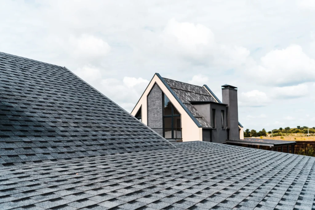 Close-up of asphalt shingle roof edge and architectural details on a modern Long Island home