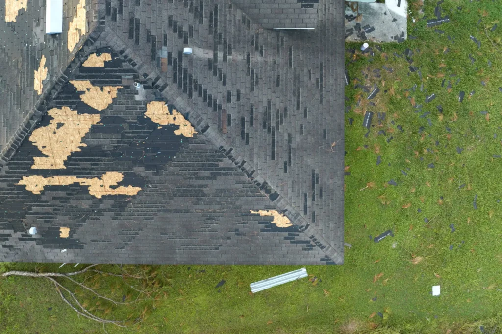 Damaged asphalt shingle rooftop in need of professional roof repair