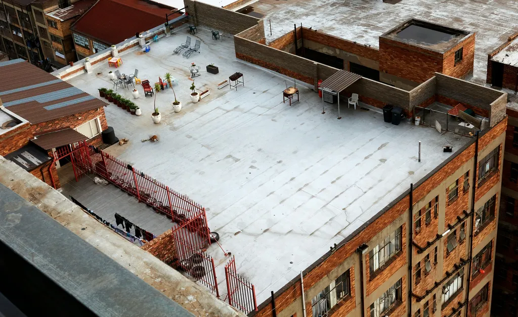 Aerial view of a Northport, NY flat roof holding standing water and snow, showing drainage failure